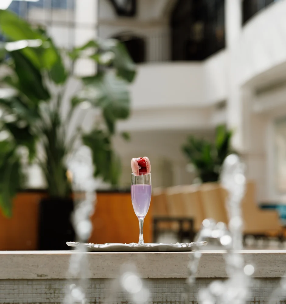 Champagne glass with strawberry by indoor fountain