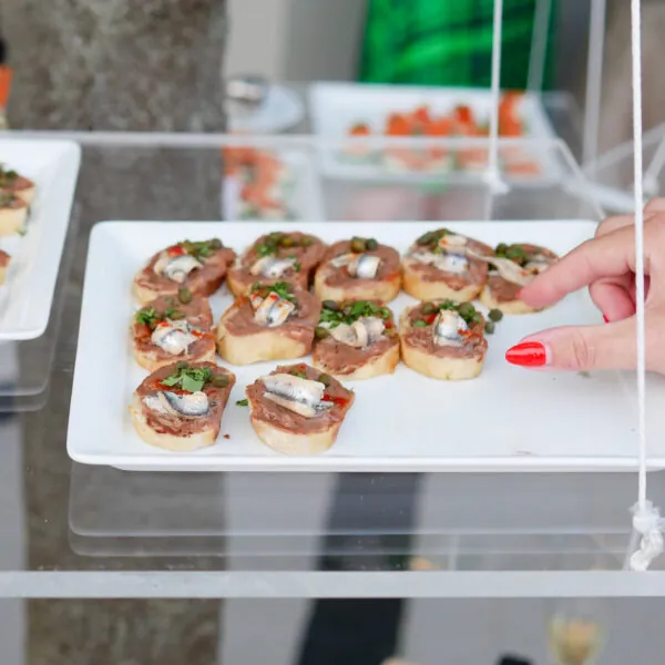 Hand serving small appetizer bites