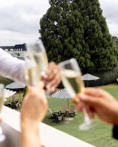 Close-up of champagne glasses clinking