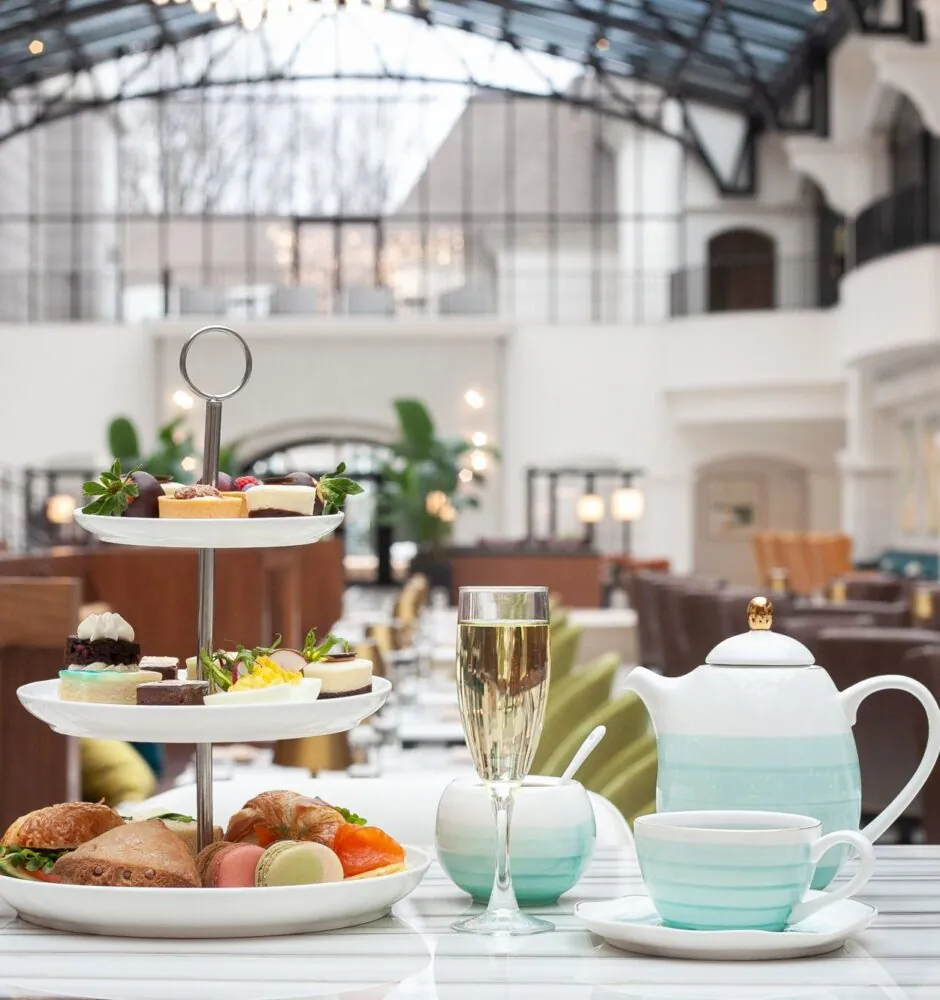 Afternoon tea set with pastries and tea in elegant dining area